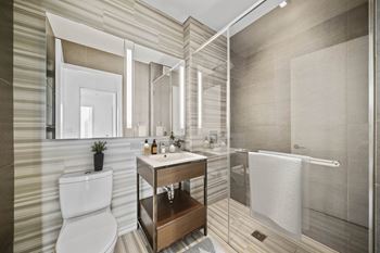 A bathroom with a toilet sink and shower